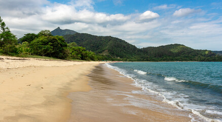Sea with green waters, rocks and mountains in the background on an island (Ilha do Pelado) Rio de Janeiro