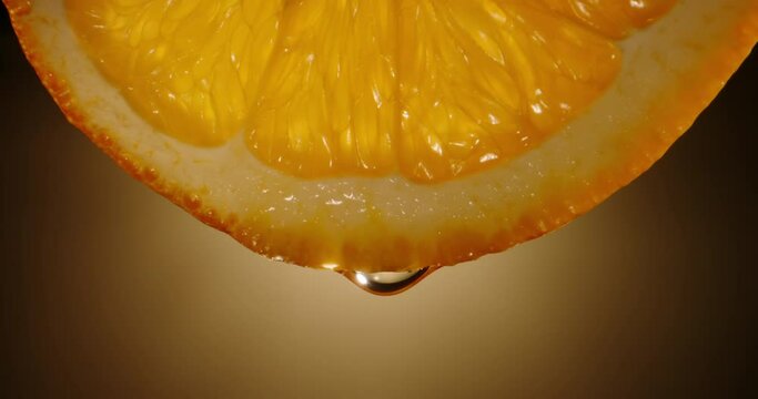 Water dropping from yellow pulp of fresh citrus fruit. Close up orange slice rich in vitamin c used for detoxification drinks 4k footage