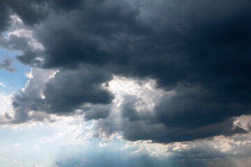 Fototapeta na wymiar Dark clouds with sun rays . Heaven before thunderstorm 