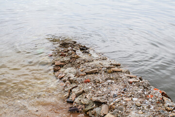 Small path made of stones and sand that stay above the surface of water.