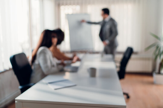 Blurred background image of business people at meeting