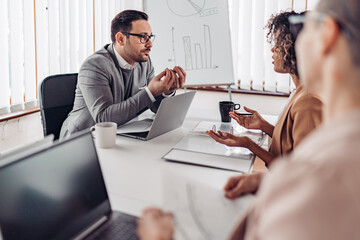 Portrait of businessman discussing with a client