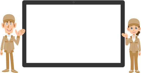 横置きのタブレットPCの前で案内する作業着を着た男女
