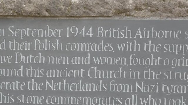 Medium pan over World War 2 memorial stone at the Old Church in Oosterbeek, the Netherlands