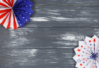 Decorations for 4th of July day of American independence, flag, candles, straws, paper fans. USA holiday decorations on a wooden background, top view, flat lay