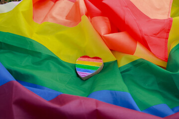 Rainbow heart on LGBTQ rainbow  Flag. Happiness, freedom and love concept for same sex couples, lgbt pride flag.