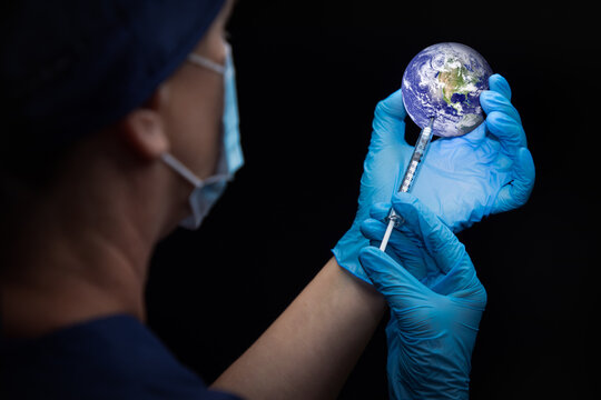 Doctor or Nurse Administiring Vaccine Through Syringe Into the Planet Earth - Powered by Adobe