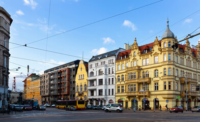 Wroclaw modern cityscape with wide streets and traditional historical tenement houses in sunny spring day, Poland. High quality photo