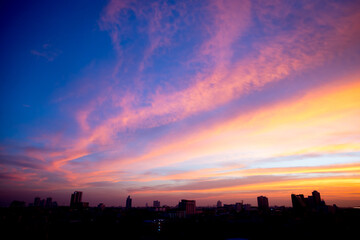 Fototapeta na wymiar Sunset sky with city in the shadow
