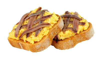 Scotch woodcock lightly scrambled eggs on toast topped with anchovy fillets an old traditional British meal isolated on a white background