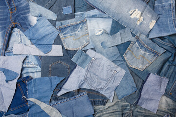 Old denim garbage background. Recycling old jeans. Old blue jeans ready for recycling on wooden table. Denim upcycle. Circular economy. Pile of discarded old blue jeans. Zero waste - 430513932