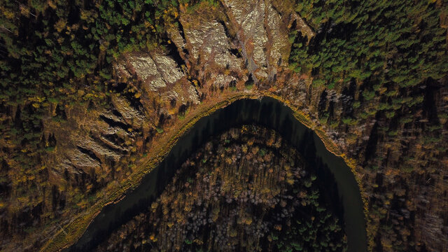 Aerial view of the bend of the Berd river next to the rocky ledges of the Berd rocks in autumn, Siberia photo by drone