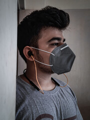 person with headphones wearing mask