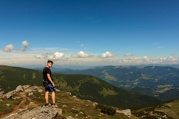 Naklejka premium Tourists and mountains of the Montenegrin ridge, endless landscapes and the silence of the mountains.