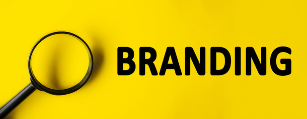 Text BRANDING written over yellow background. Magnifying glass on yellow background. Minimal we are...
