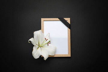 Photo frame with lily flower on dark background