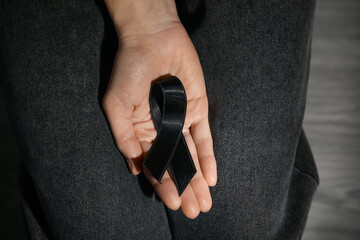 Woman with black funeral ribbon, closeup