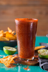 Mexican alcohol cocktail michelada with dark beer and lime juice
