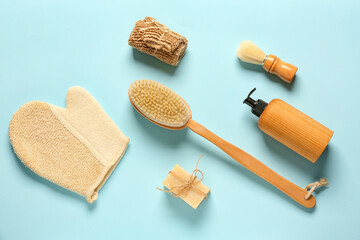 Composition with massage brush and bath supplies on color background