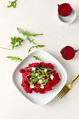 Plate with tasty beet risotto on light background