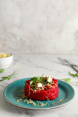 Plate with tasty beet risotto on light background