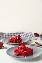 Plates with tasty beet risotto on light background