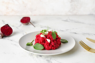 Plate with tasty beet risotto on light background