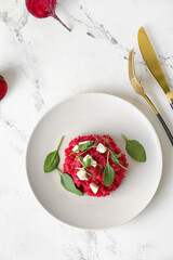 Plate with tasty beet risotto on light background