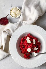 Plate with tasty beet risotto on light background
