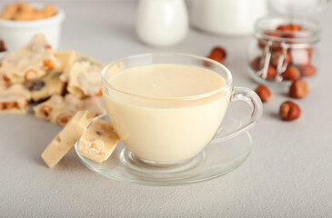 Obraz na płótnie Canvas Cup with hot white chocolate on light background