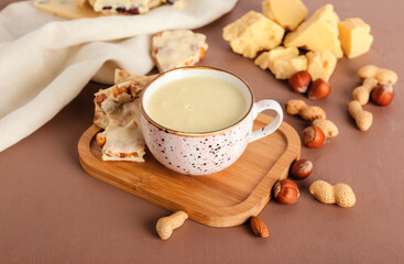 Obraz na płótnie Canvas Cup with hot white chocolate on color background