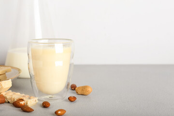 Cup with hot white chocolate on light background