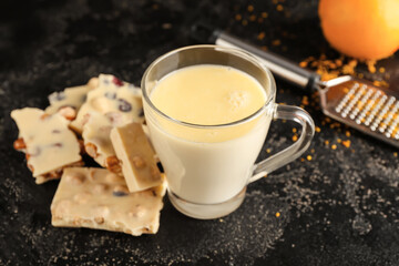 Cup with hot white chocolate on dark background
