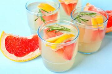 Glasses of tasty grapefruit lemonade on color background