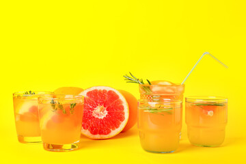 Glasses of tasty grapefruit lemonade on color background
