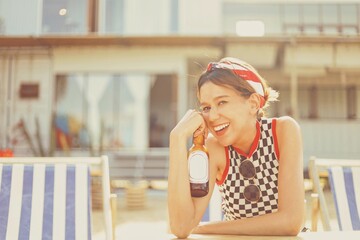 Happy Woman drinking soda on the beach