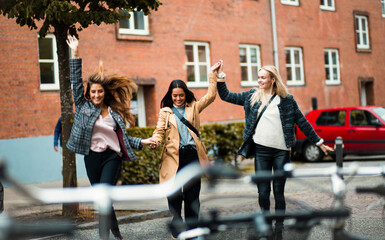 Fototapeta premium Three women having fun on the street.