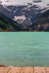 Fototapeta na wymiar Blue water lake and snowy mountains