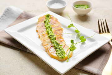Tasty grilled potatoes with pesto sauce on light background, closeup