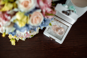 wedding rings and bridal bouquet, hands with bouquet