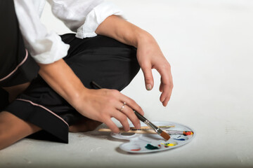 artist's paints and brushes, artist's hands