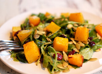 salad with pumpkin, pumpkin seeds and arugula