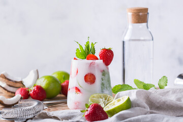 Tropical Caribbean cocktail mojito with coconut cream, strawberry and seltzer