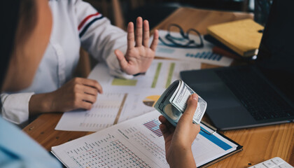 Businesswoman rejecting money in white envelope offered by his partner in the dark - anti bribery concept.