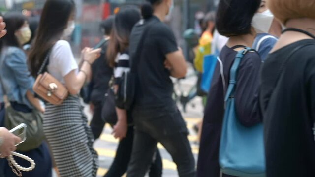 Slow motion of unrecognized people wearing medical face mask in Hong Kong. Coronavirus concept