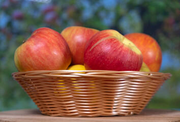 red apples in a wicker basket close up