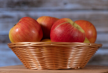 red apples in a wicker basket close up