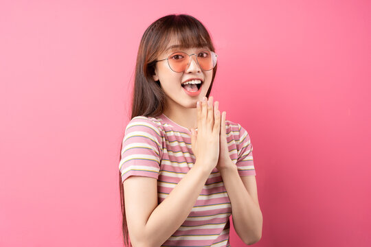Image of young Asian girl wearing pink t-shirt on pink background
