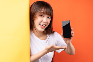 Young Asian girl showing smartphone with empty display