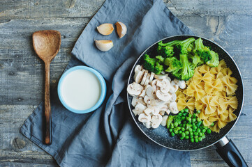 ingredients for cooking tasty one pot italian pasta with broccoli, mushrooms, sweet beans in creamy sauce